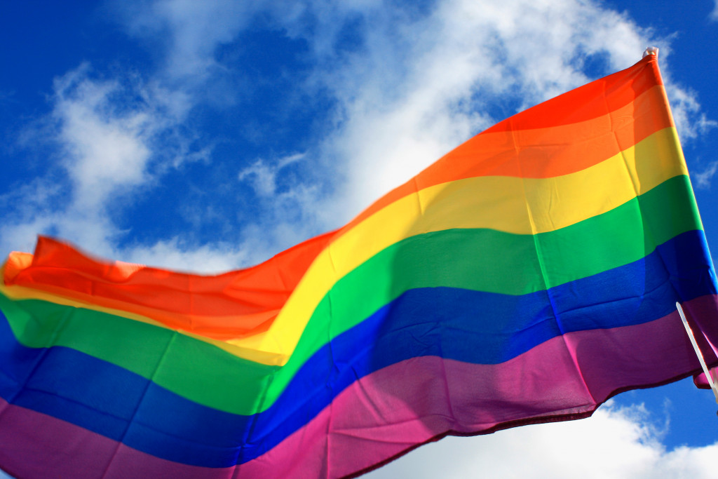 Rainbow flag (LGBT movement) on the sky background