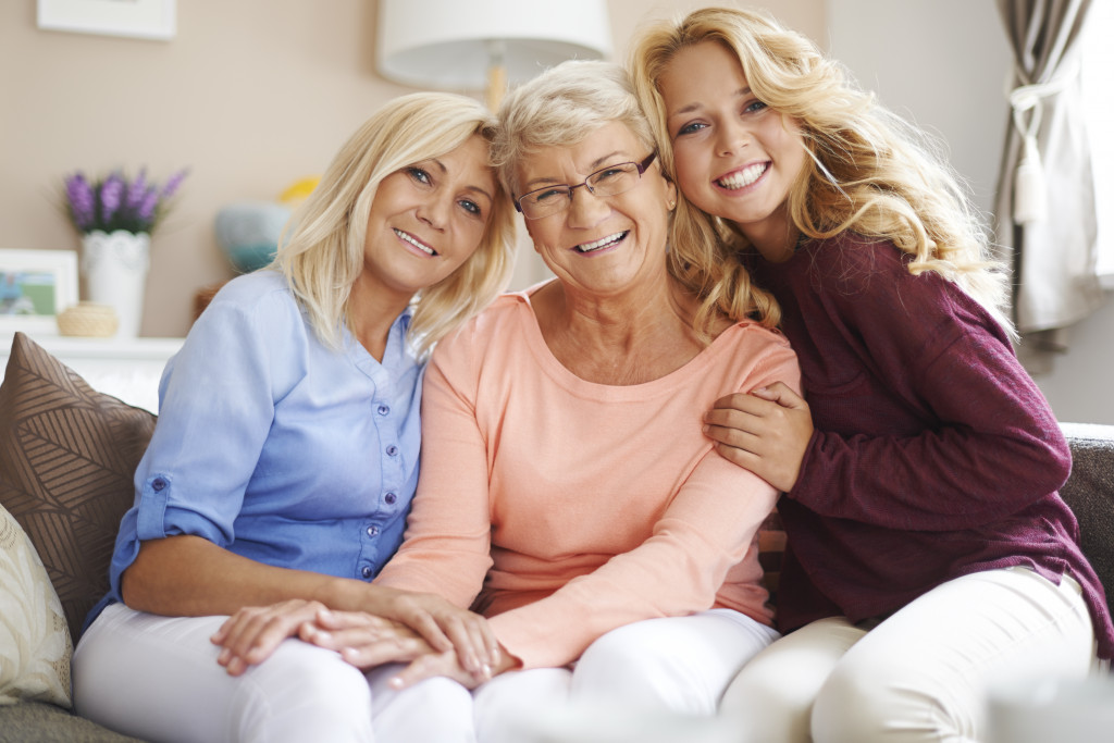 A mother, grandmother, and granddaughter in a home living room