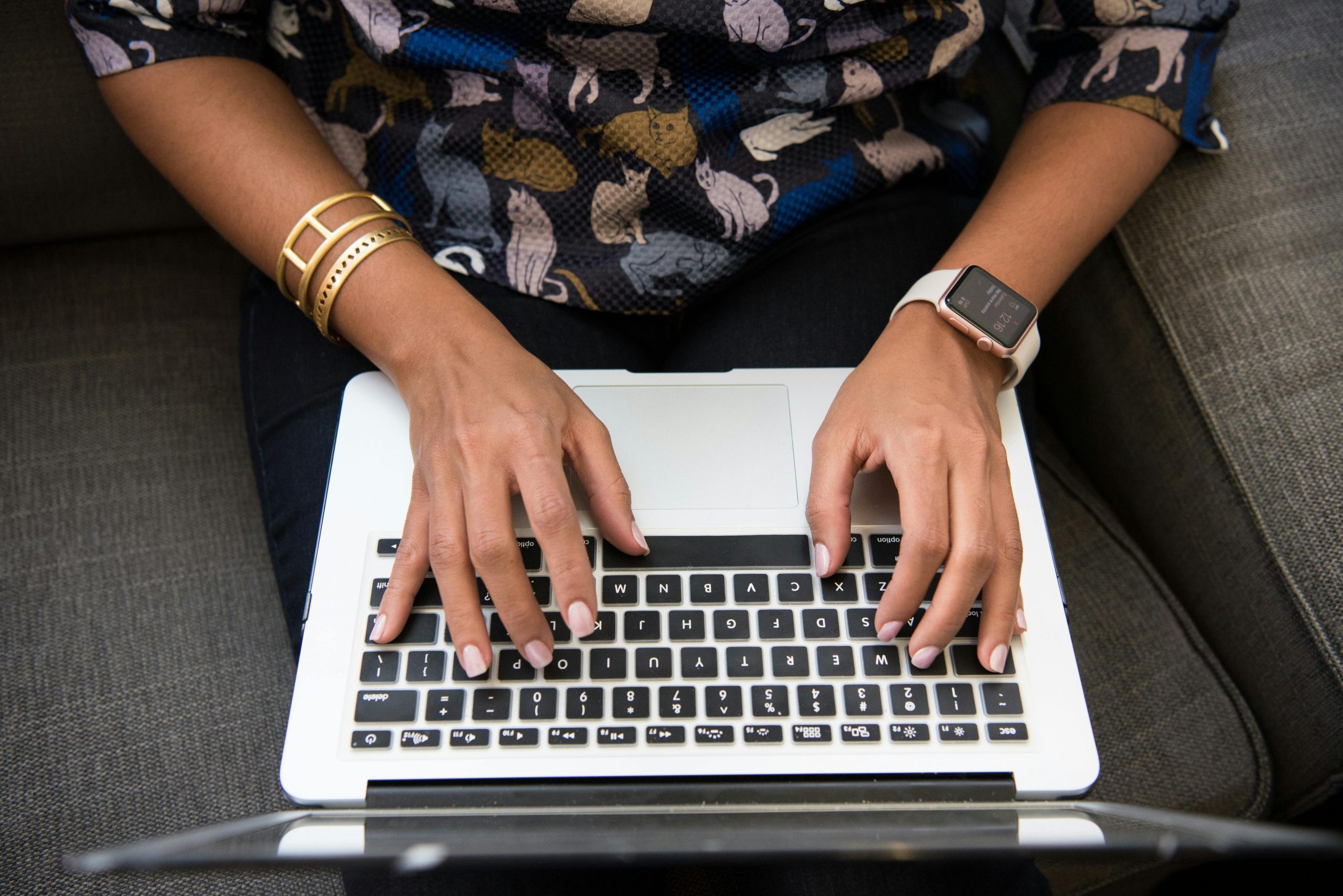 close-up of hands typing on a laptop